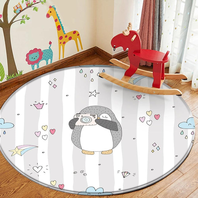 Rundt legetæppe med pingvin og kamera