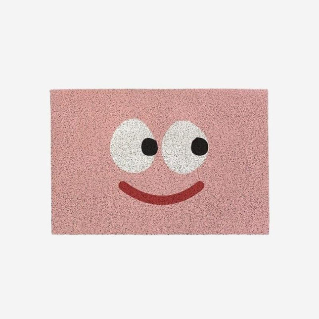 Lyserød dørmåtte med stort smiley design