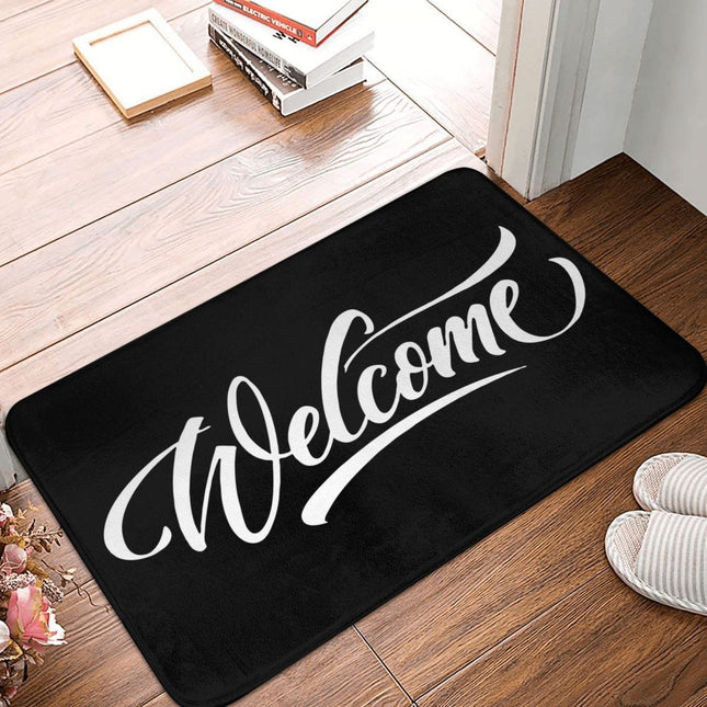Sort dørmåtte med hvidt 'Welcome' print