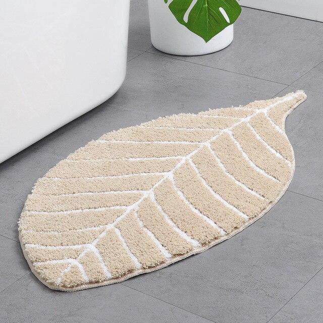 Beige bademåtte formet som et blad