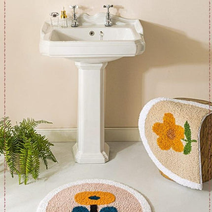 Halvrund bademåtte med gul blomst