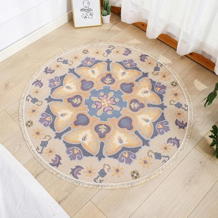 Rundt stuetæppe i beige og lilla